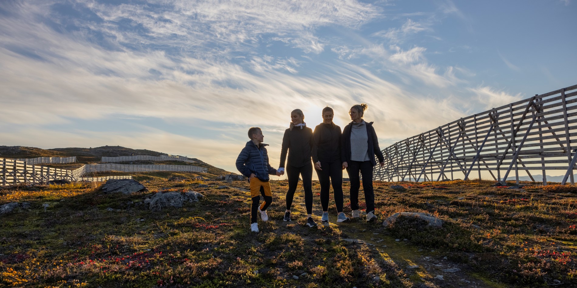Three adults and a child on a hike in Hammerfest
