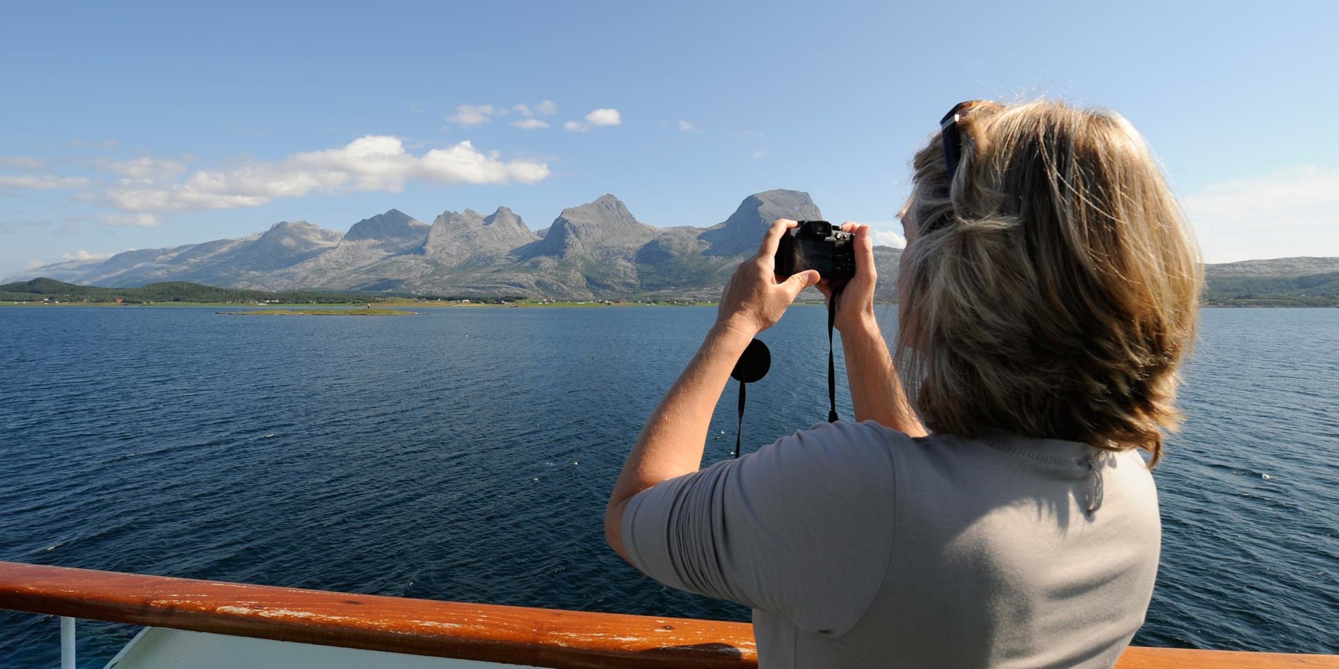 Passenger photographing the Seven Sisters from deck