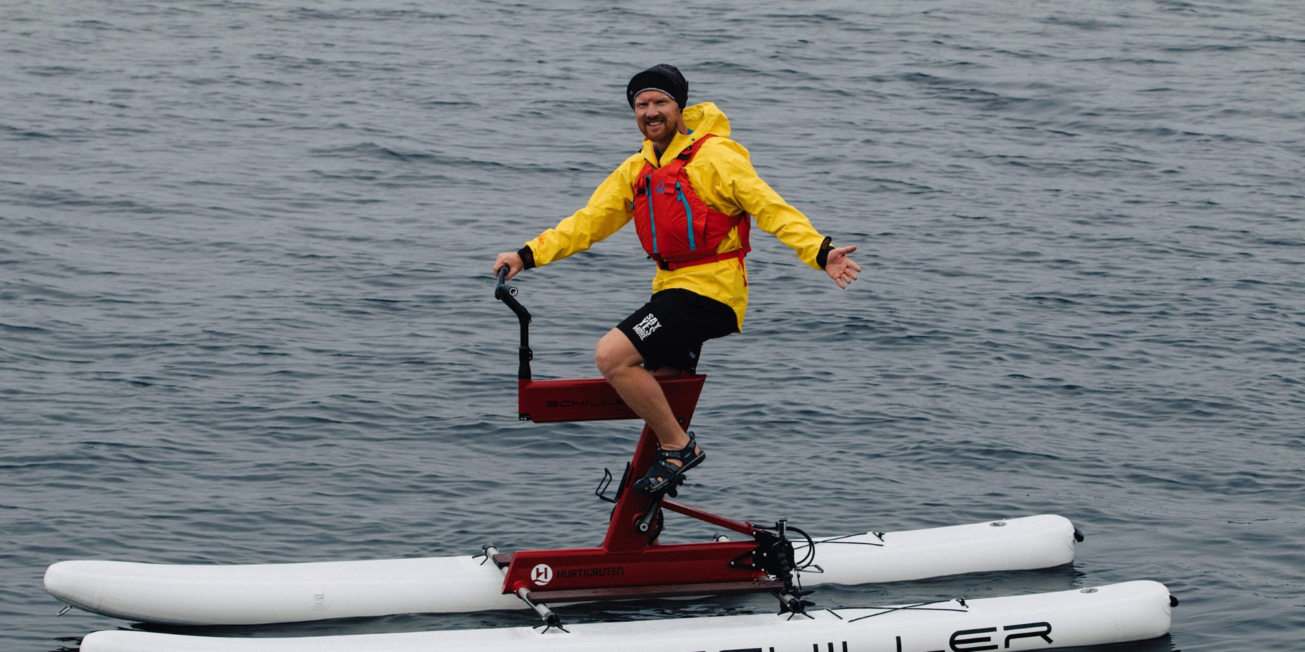 David Cornthwaite riding on the back of a boat in a body of water