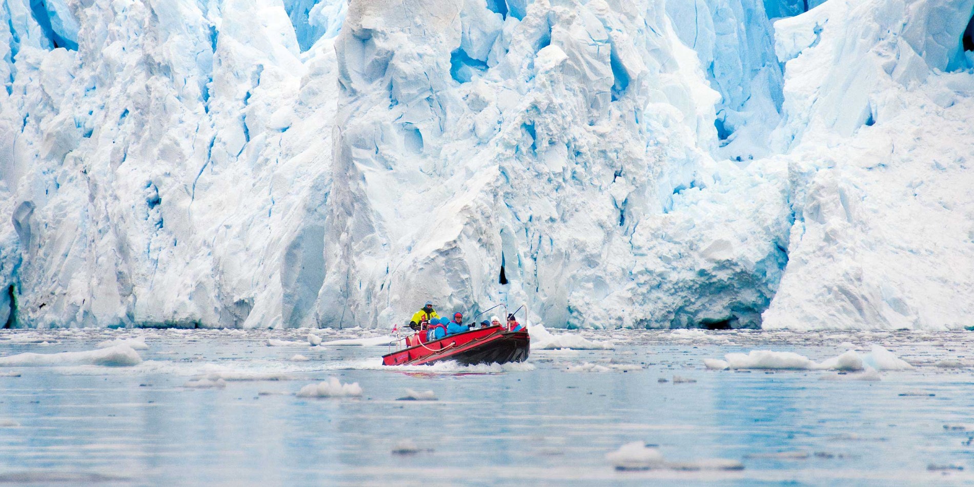 Polarcirkel boat going past Antartic iceberg